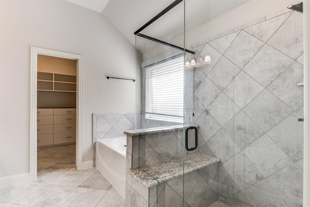 bathroom with lofted ceiling and independent shower and bath