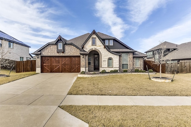 view of front of property featuring a front lawn and a garage