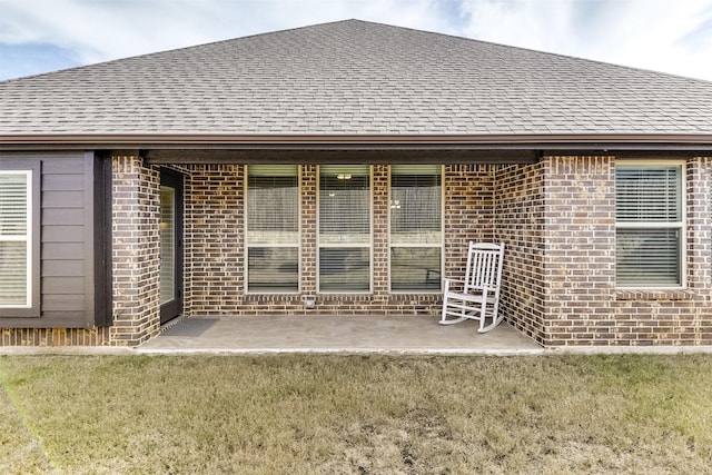 back of property featuring a yard and a patio