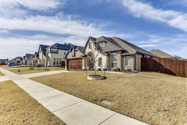 view of front of house with a front lawn and a garage