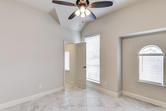 tiled empty room featuring lofted ceiling, ceiling fan, and plenty of natural light