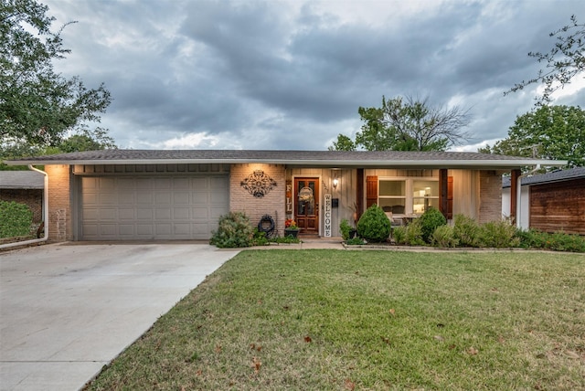 ranch-style house featuring a front yard and a garage