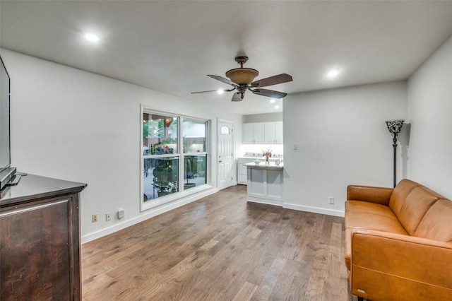 living room featuring hardwood / wood-style flooring and ceiling fan