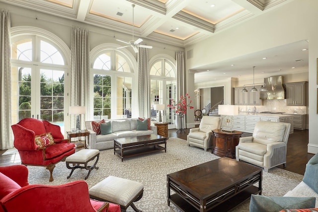 interior space with ceiling fan, beam ceiling, french doors, and coffered ceiling