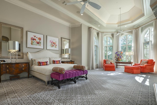 bedroom featuring a high ceiling, ornamental molding, carpet flooring, ceiling fan, and a tray ceiling