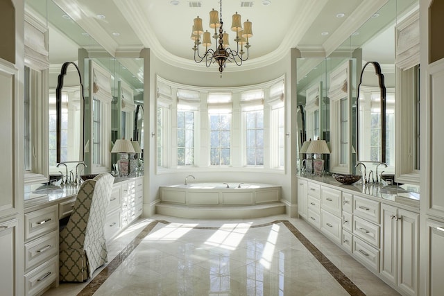 bathroom with a bath, ornamental molding, a chandelier, and vanity