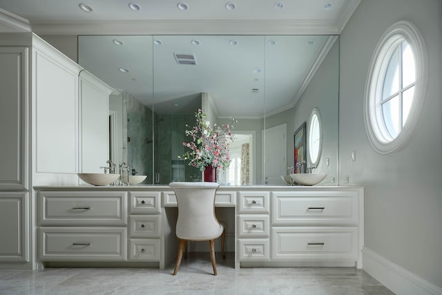 bathroom with a shower with door, vanity, and crown molding