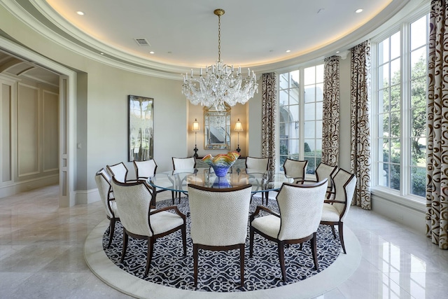 dining area with an inviting chandelier and ornamental molding