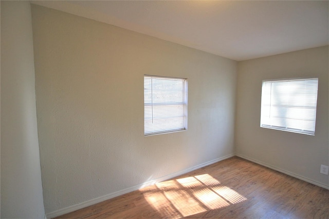 unfurnished room with hardwood / wood-style floors