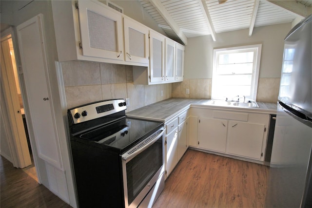 kitchen featuring hardwood / wood-style floors, appliances with stainless steel finishes, white cabinets, and sink