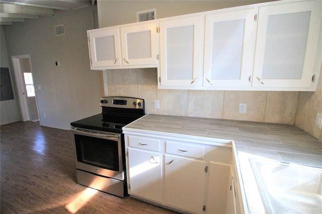 kitchen featuring backsplash, tile countertops, stainless steel electric range, white cabinetry, and dark hardwood / wood-style flooring