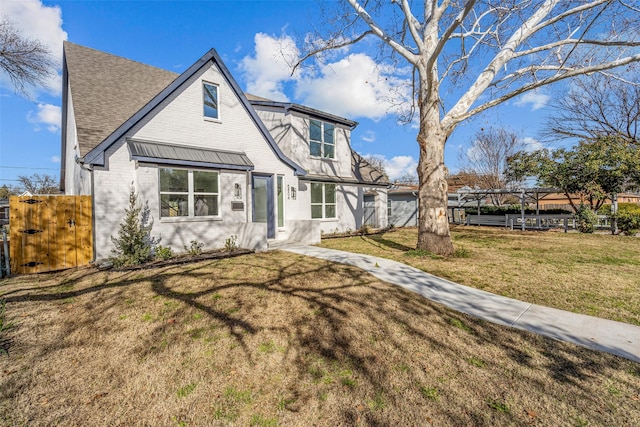 tudor home featuring a front yard