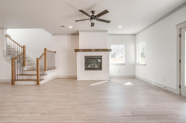 unfurnished living room with light wood-type flooring, ceiling fan, and ornamental molding