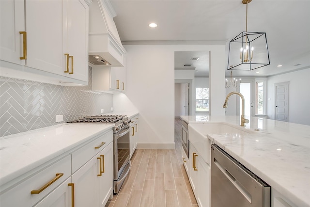 kitchen with decorative light fixtures, white cabinetry, stainless steel appliances, and custom exhaust hood