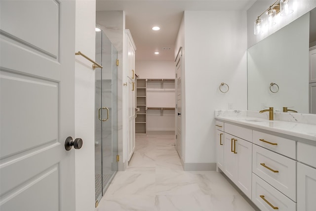 bathroom with walk in shower and vanity