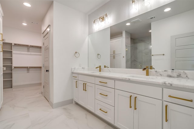 bathroom with walk in shower and vanity