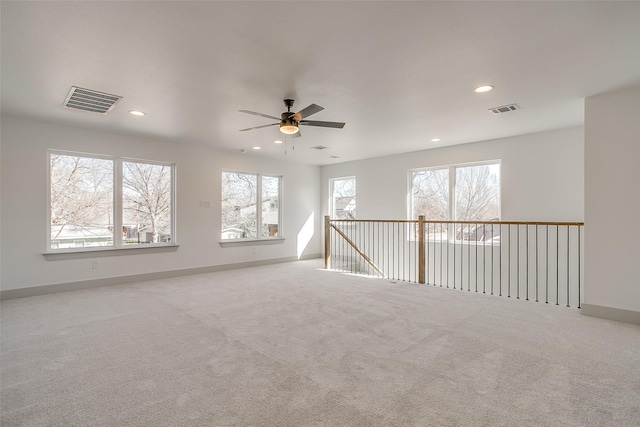 unfurnished room featuring ceiling fan and light colored carpet