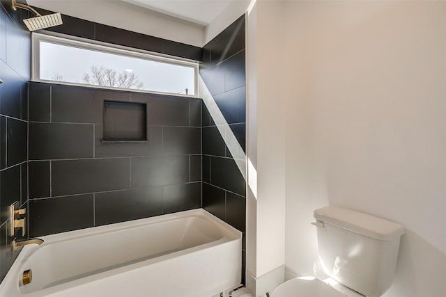 bathroom with toilet and tiled shower / bath combo