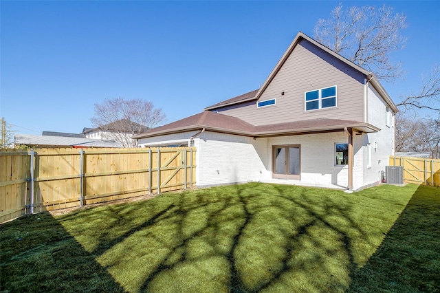 rear view of property featuring cooling unit and a lawn