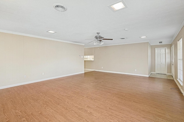 empty room featuring ceiling fan, light wood-type flooring, and crown molding