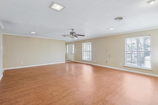 unfurnished room featuring ceiling fan, crown molding, a textured ceiling, and light hardwood / wood-style flooring