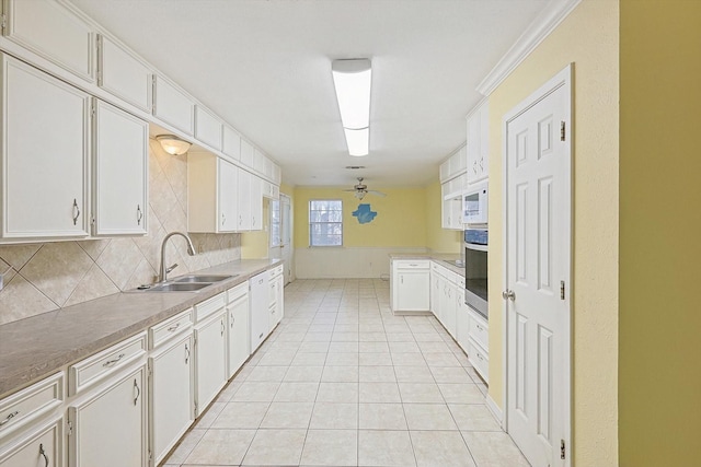 kitchen with ceiling fan, backsplash, and white cabinetry