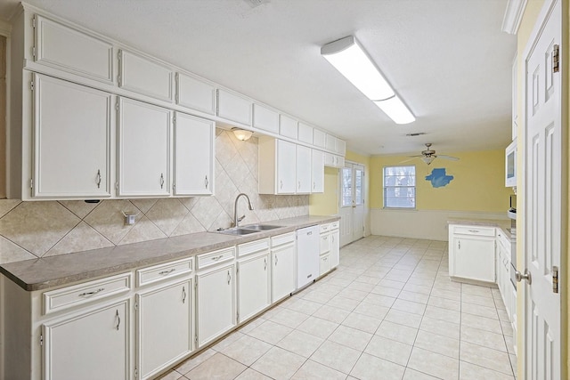 kitchen featuring white cabinets, sink, and white dishwasher