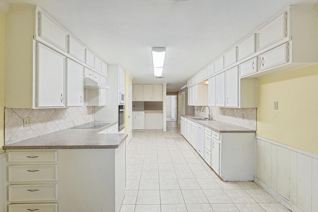 kitchen featuring light tile patterned floors, black electric stovetop, oven, white cabinets, and sink