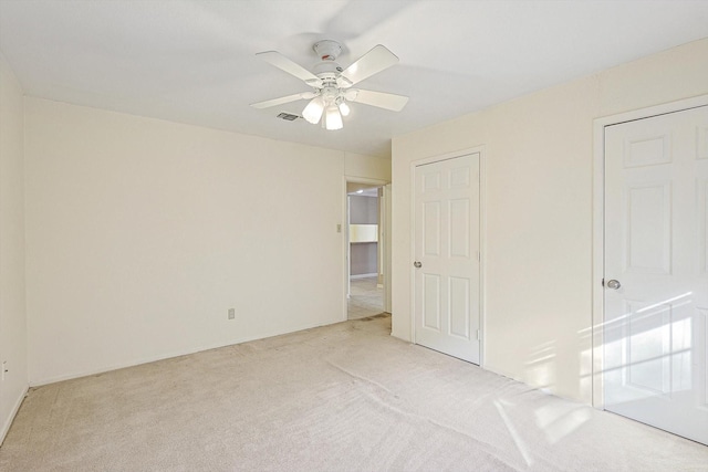 unfurnished bedroom with ceiling fan and light carpet