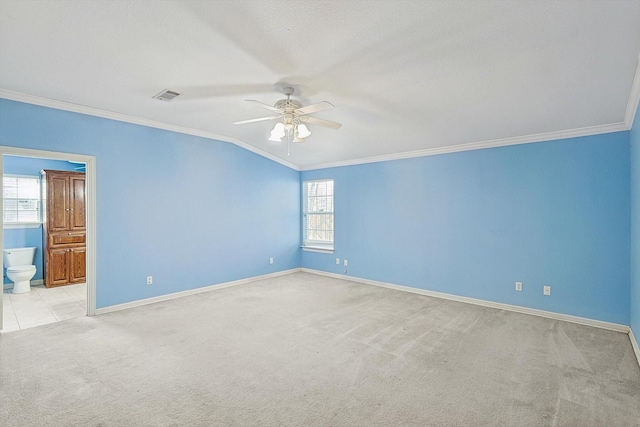 carpeted spare room with ceiling fan and ornamental molding