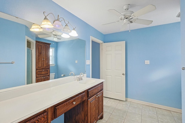 bathroom with toilet, ceiling fan, tile patterned flooring, walk in shower, and vanity