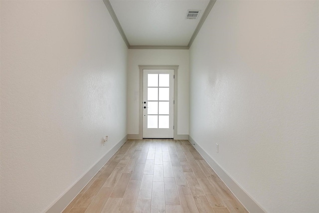 entryway featuring light hardwood / wood-style floors and ornamental molding