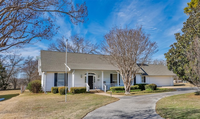 ranch-style home with a front lawn, a garage, and a porch