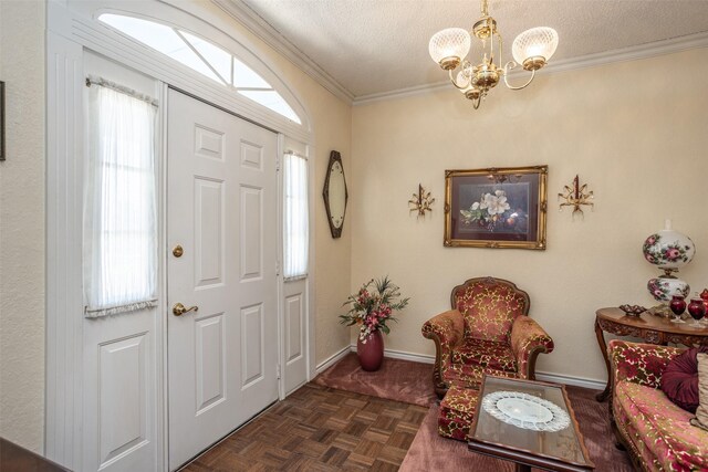 entrance foyer with dark parquet floors, a textured ceiling, a chandelier, and ornamental molding