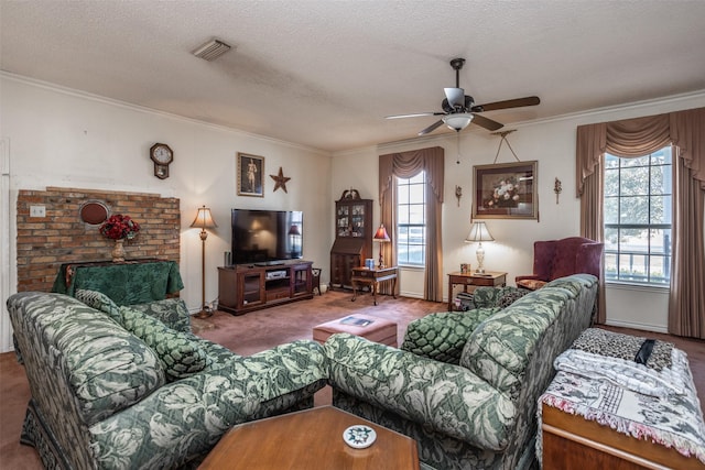 carpeted living room with a textured ceiling, ceiling fan, and a wealth of natural light