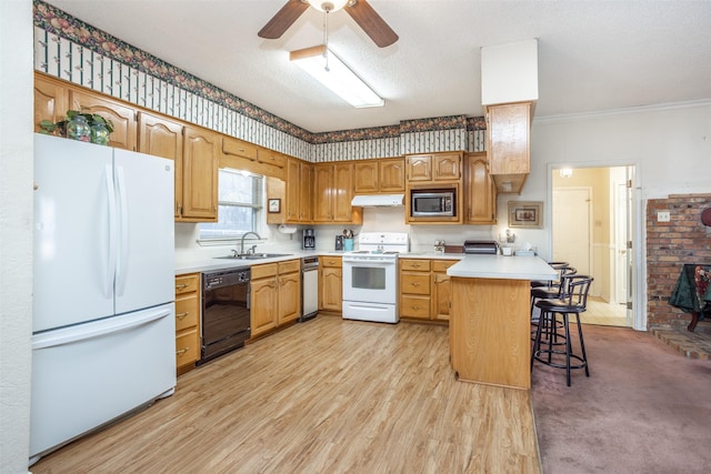 kitchen featuring white appliances, a textured ceiling, sink, kitchen peninsula, and a breakfast bar area