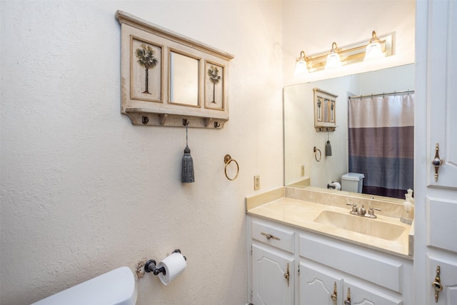 bathroom with toilet and vanity