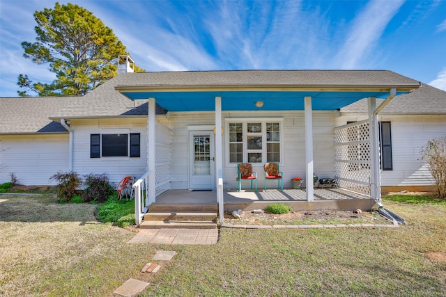 ranch-style house with a front yard and a porch