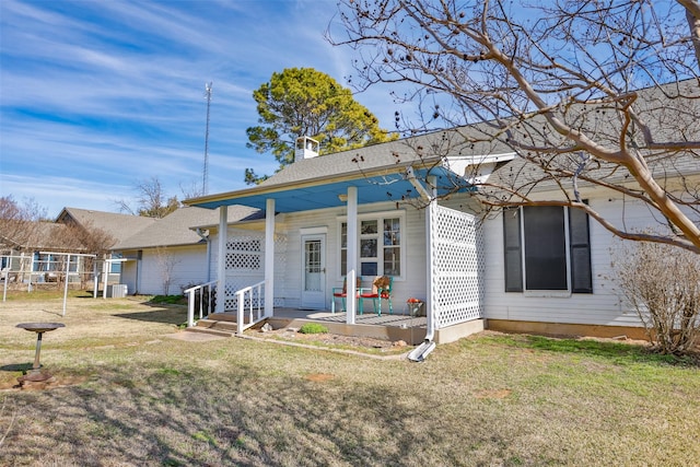 view of front of home featuring a front yard and central air condition unit