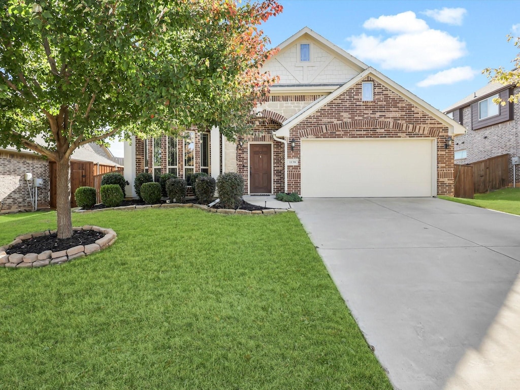 view of front of house with a front lawn and a garage