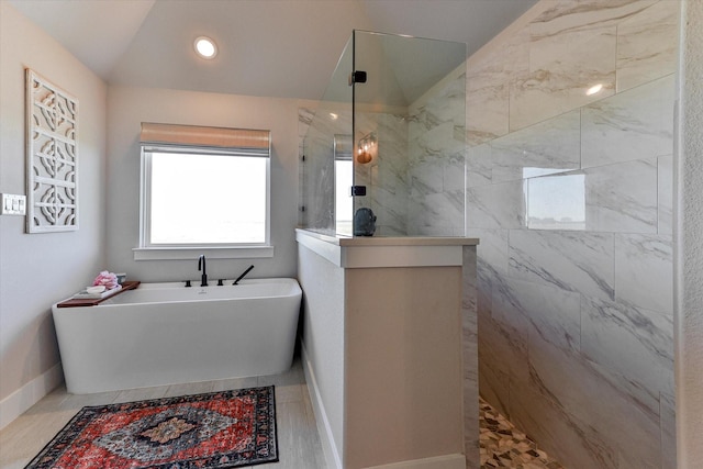 bathroom featuring lofted ceiling and independent shower and bath