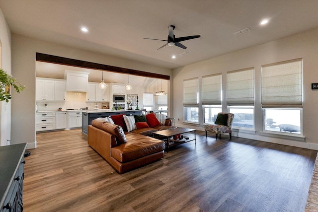 living room with hardwood / wood-style flooring and ceiling fan