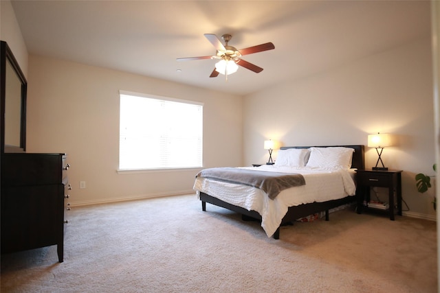 bedroom featuring light carpet and ceiling fan