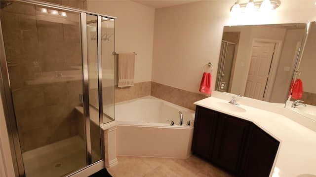 bathroom with plus walk in shower, tile patterned flooring, and vanity