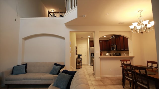 living room featuring light tile patterned floors and a notable chandelier