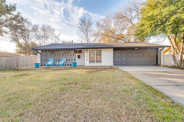 single story home with a front yard and a garage