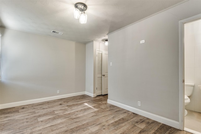 spare room with light hardwood / wood-style flooring