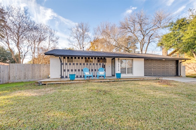 view of front of house featuring a front lawn, a garage, and a porch