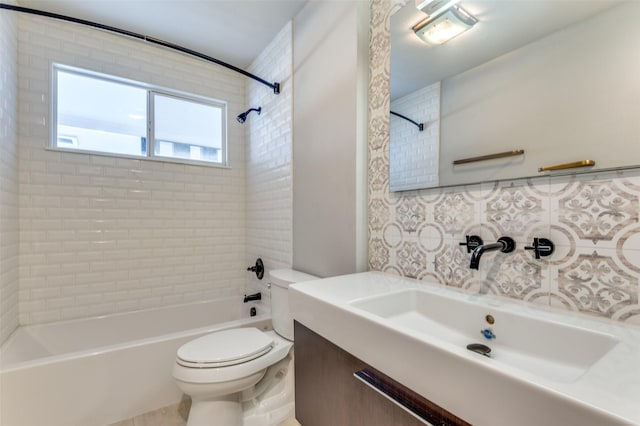 full bathroom featuring vanity, decorative backsplash, toilet, and tiled shower / bath