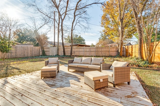 wooden terrace with an outdoor living space